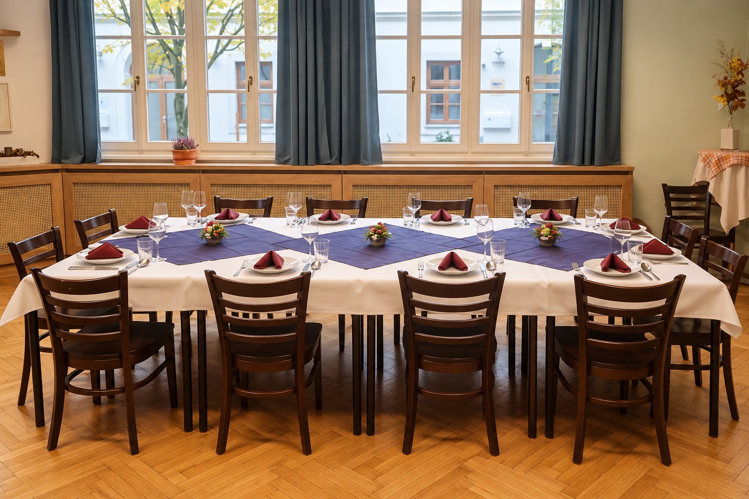 Praderzimmer mit gedeckter Tafel und großen Fenstern